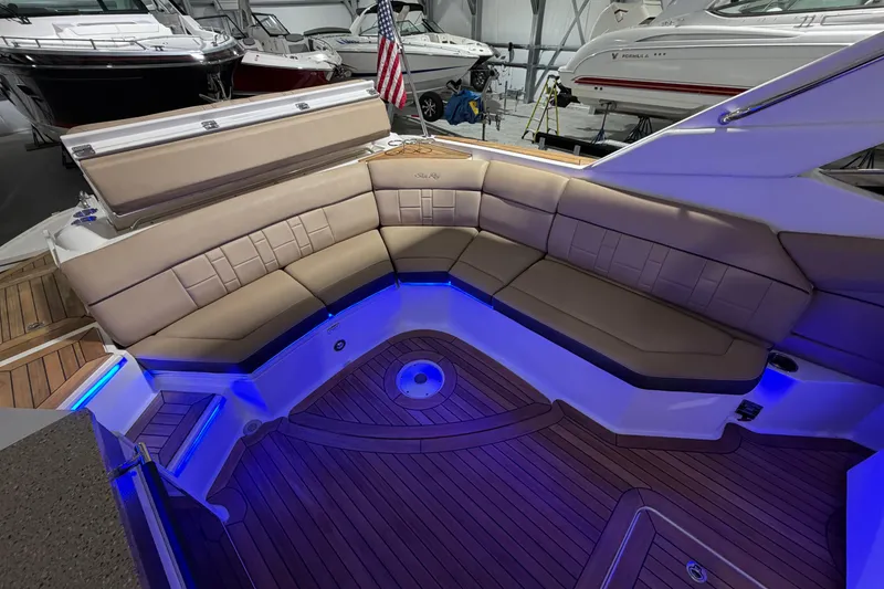 Slide: The Image of Interior cabin of 2016 Sea Ray 350 SLX with beige seating and wooden flooring. - 55