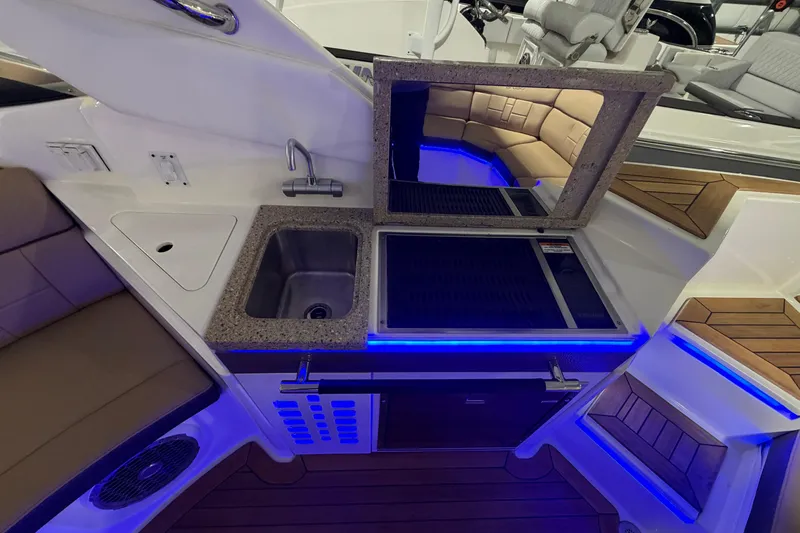 Slide: The Image of 2016 Sea Ray 350 SLX boat interior in a storage facility with other boats. - 57