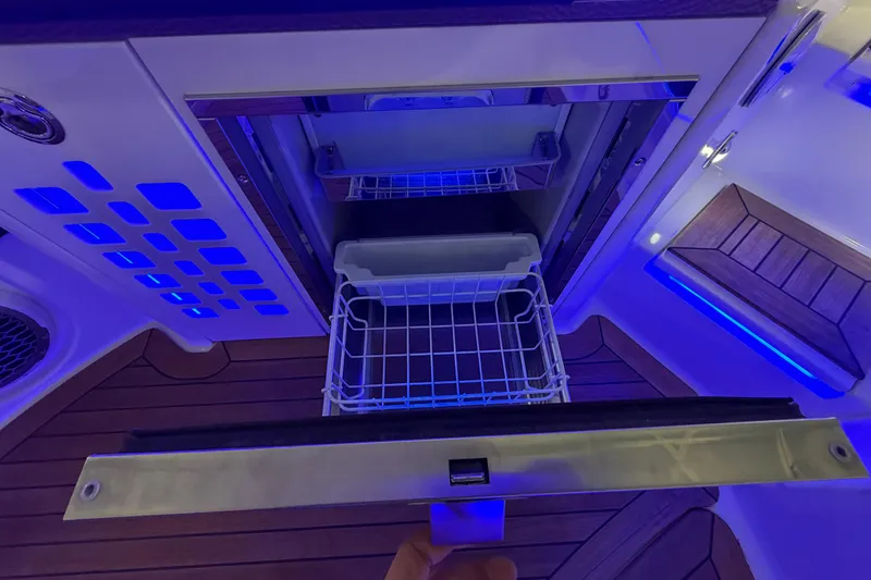 Slide: The Image of 2016 Sea Ray 350 SLX boat with extended swim platform in a storage facility. - 59