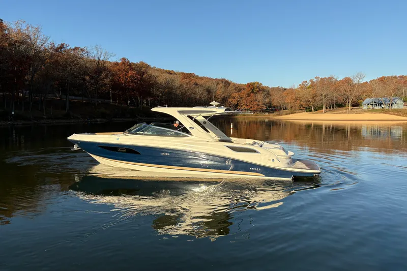 Slide: The Image of 2016 Sea Ray 350 SLX boat cruising on a calm lake with autumn trees. - 7