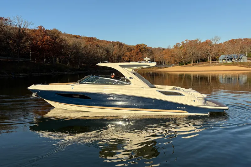 Slide: The Image of 2016 Sea Ray 350 SLX boat with MerCruiser propellers in a sunny outdoor setting. - 8