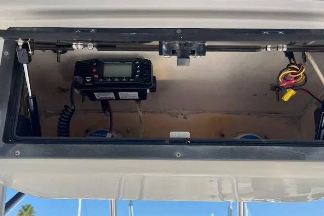 Slide: The Image of 2007 Sea Hunt Triton 207 boat compartment with radio and wiring. - 12
