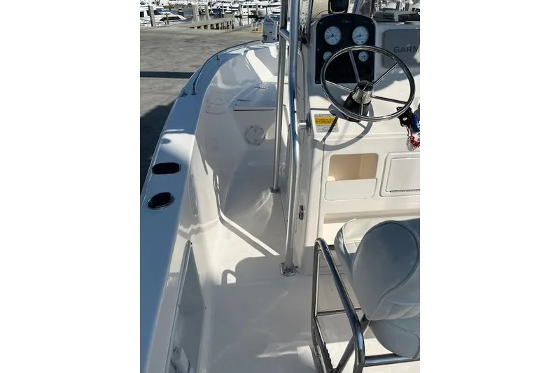 Slide: The Image of 2007 Sea Hunt Triton 207 boat interior with steering wheel and seating. - 13