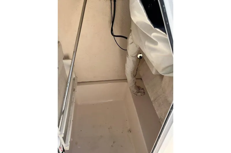 Slide: The Image of 2007 Sea Hunt Triton 207 interior storage compartment with wiring and cover. - 15