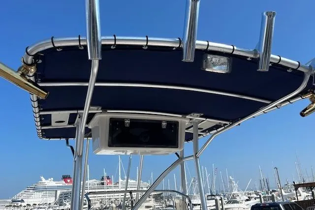 Slide: The Image of 2007 Sea Hunt Triton 207 boat with T-top, docked in marina, cruise ship in background. - 16