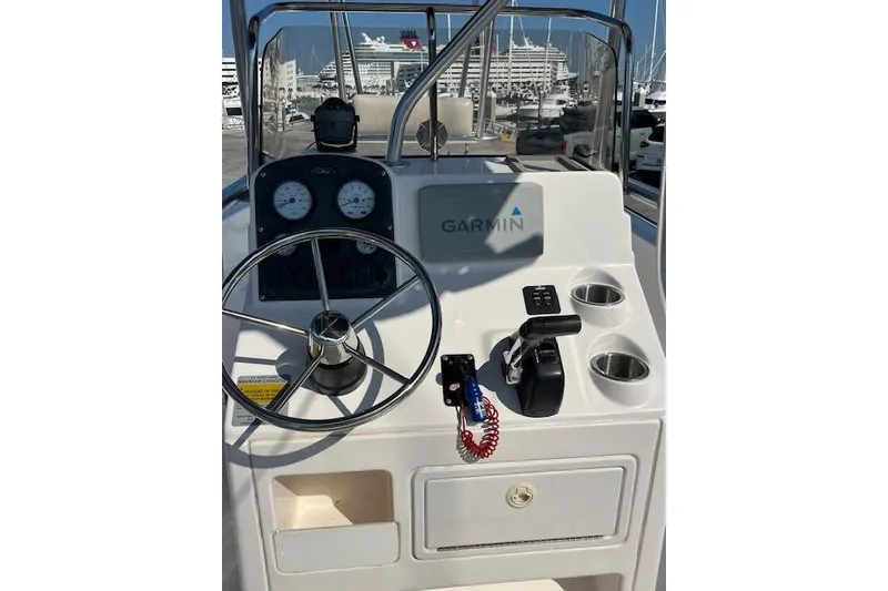 Slide: The Image of 2007 Sea Hunt Triton 207 boat console with Garmin navigation system and steering wheel. - 18