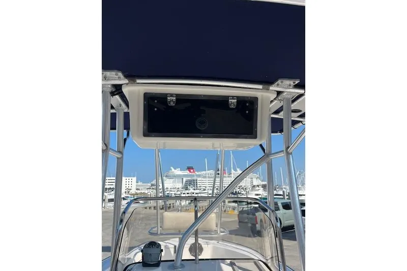 Slide: The Image of 2007 Sea Hunt Triton 207 boat with T-top, docked at marina, cruise ship in background. - 19