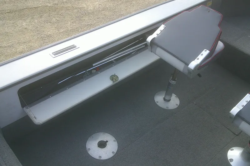 Slide: The Image of 1997 Lund 1660 Pro-V boat interior with seating and storage compartment. - 13