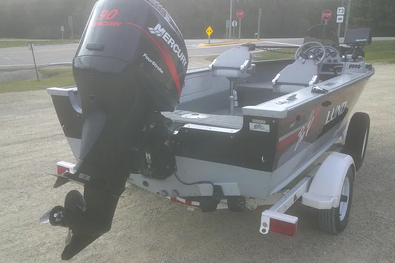 Slide: The Image of 1997 Lund 1660 Pro-V boat with Mercury 90 FourStroke engine on trailer. - 19