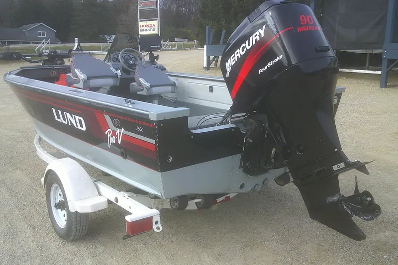 Slide: The Image of 1997 Lund 1660 Pro-V boat with Mercury 90 engine on trailer. - 20