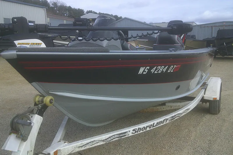 Slide: The Image of 1997 Lund 1660 Pro-V boat on trailer, parked outdoors. - 22