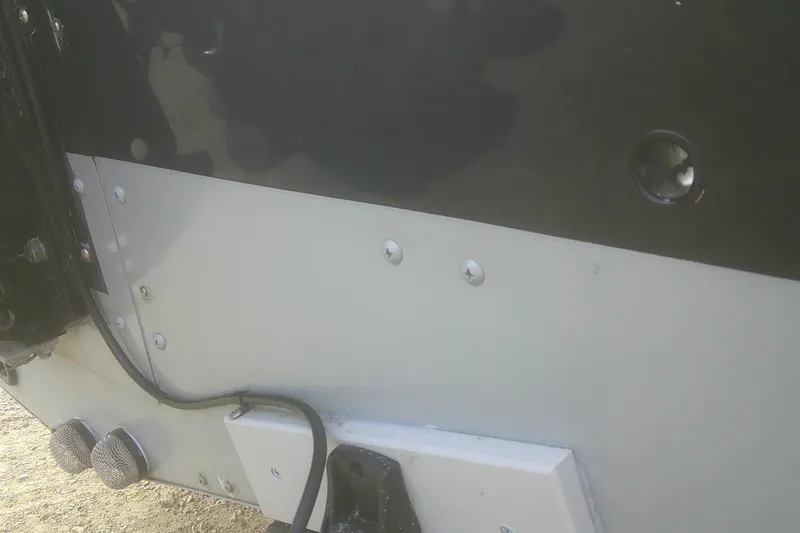 Slide: The Image of Close-up of 1997 Lund 1660 Pro-V boat hull with visible screws and wiring. - 28