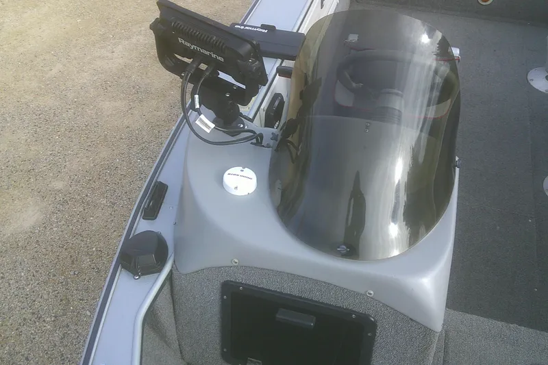 Slide: The Image of 1997 Lund 1660 Pro-V boat console with Raymarine electronics and steering wheel. - 9