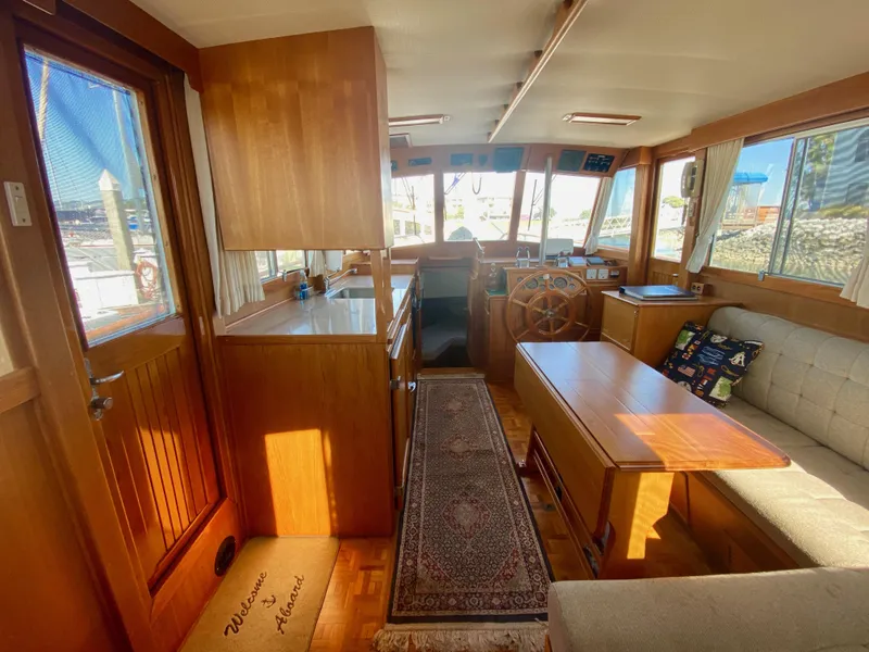 Slide: The Image of Interior of a 1997 Grand Banks Classic yacht with wood finish and cozy seating area. - 15