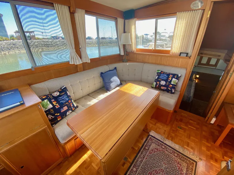 Slide: The Image of Interior of 1997 Grand Banks Classic yacht with cozy seating and wooden table. - 17