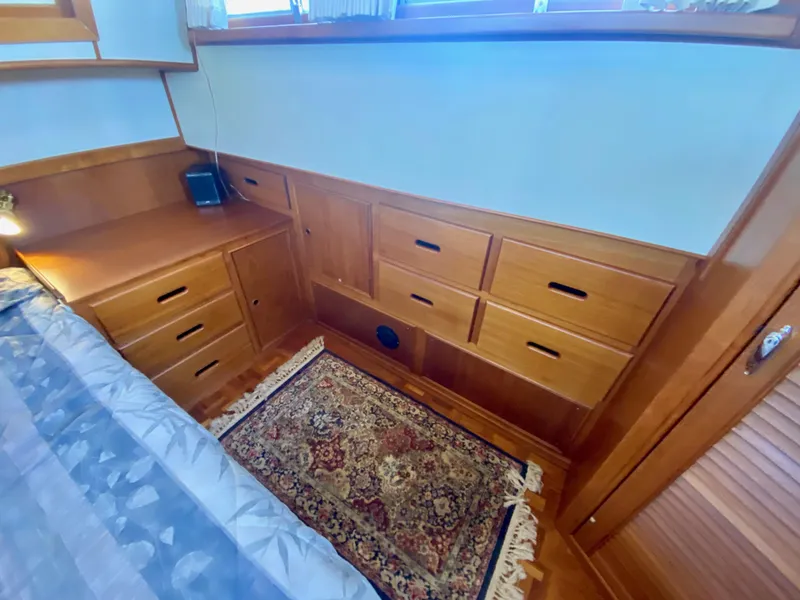Slide: The Image of Cozy cabin interior of 1997 Grand Banks Classic yacht with wooden furnishings and bed. - 29