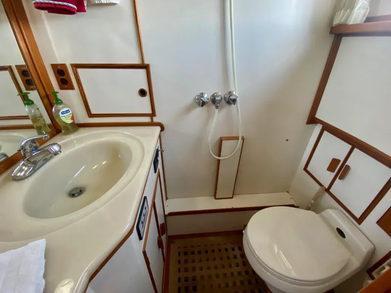 Slide: The Image of 1997 Grand Banks Classic interior with wooden cabinetry and windows, showcasing elegant nautical design. - 31