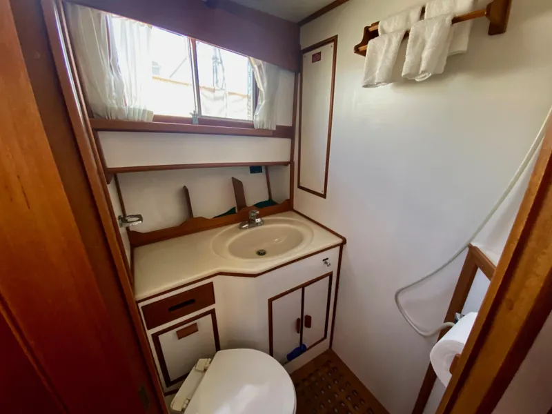 Slide: The Image of Bathroom interior of 1997 Grand Banks Classic yacht, featuring shower and toilet. - 37