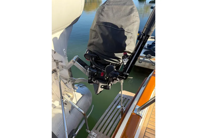 Slide: The Image of 1997 Grand Banks Classic boat with covered outboard motor and wooden deck detail. - 63
