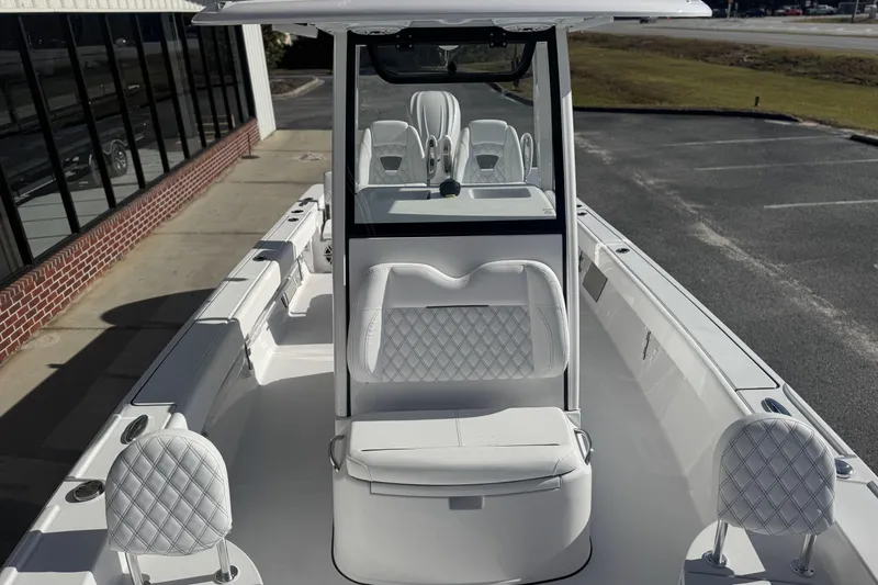 Slide: The Image of 2026 Sportsman Masters 267 Bay Boat with sleek white interior and diamond-stitched seating. - 11