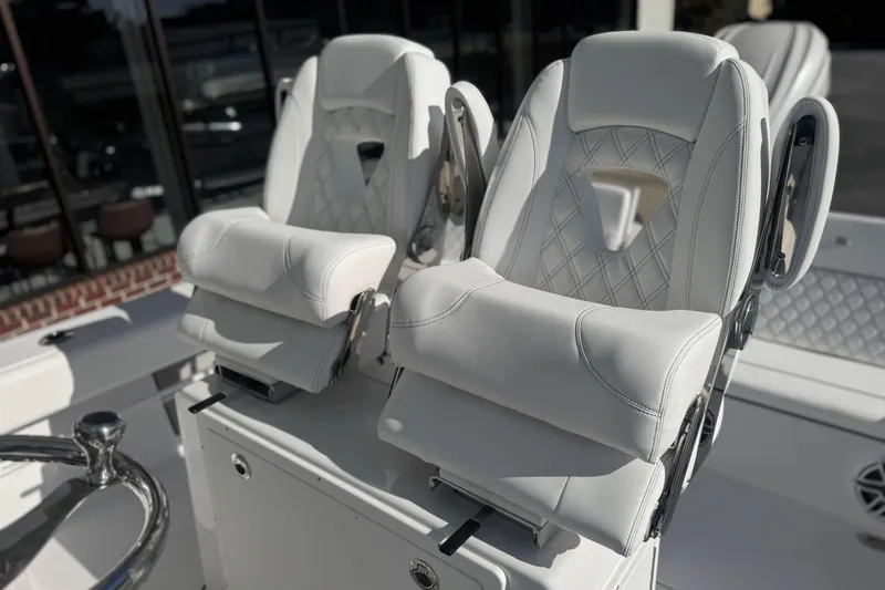 Slide: The Image of Luxurious white seating on 2026 Sportsman Masters 267 Bay Boat, featuring elegant diamond stitching. - 15