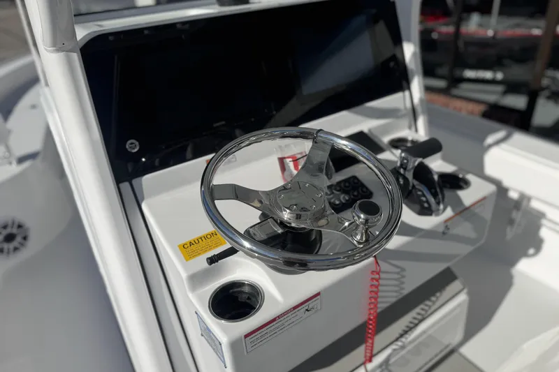 Slide: The Image of Steering console of 2026 Sportsman Masters 267 Bay Boat with modern controls. - 16