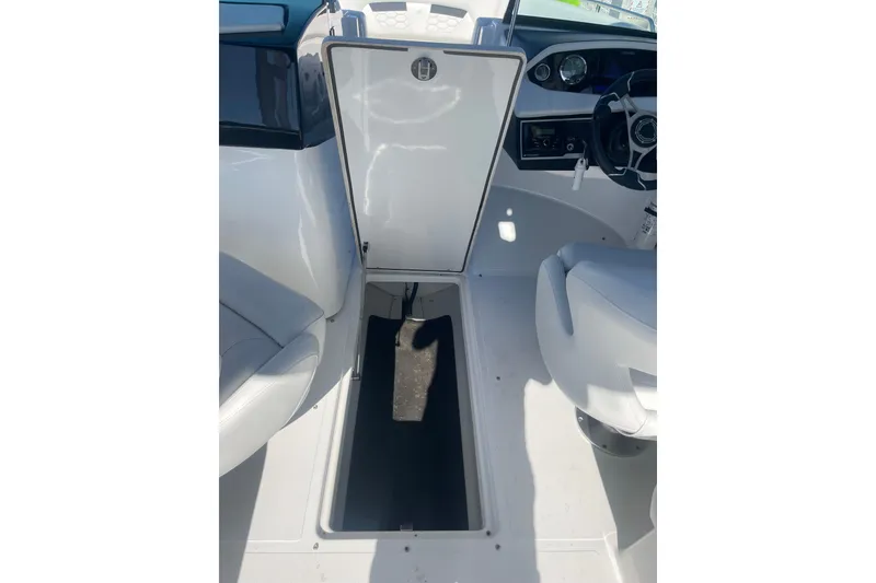 Slide: The Image of 2023 Four Winns HD5 OB boat interior with open storage compartment. - 13