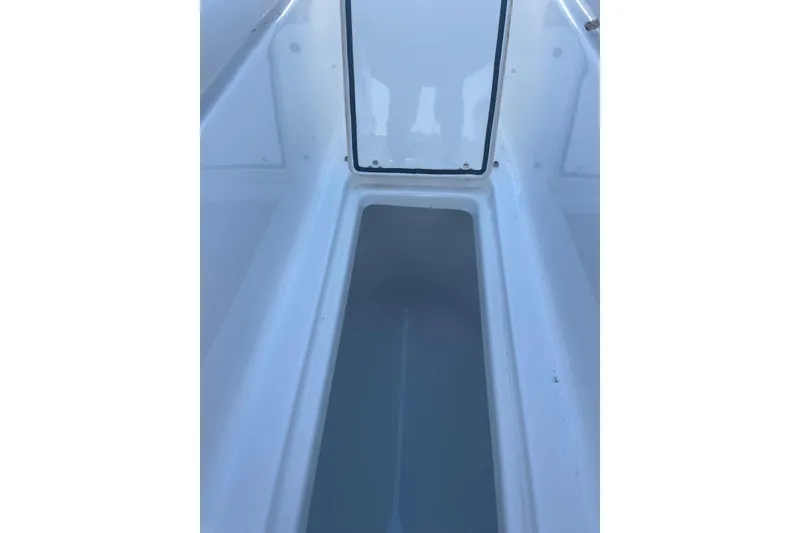 Slide: The Image of 2023 Four Winns HD5 OB boat storage compartment, white interior. - 14