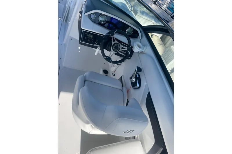 Slide: The Image of 2023 Four Winns HD5 OB boat cockpit with modern steering and controls. - 16