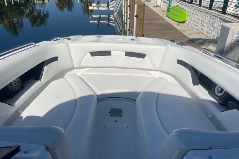 Slide: The Image of 2023 Four Winns HD5 OB boat interior with white seating and waterfront view. - 18