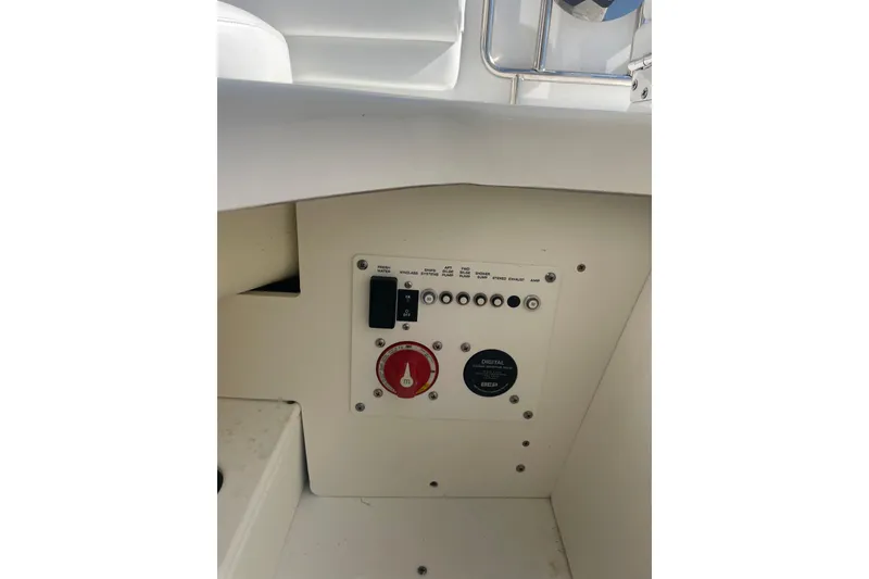 Slide: The Image of Control panel of 2023 Four Winns HD5 OB boat, featuring switches and dials. - 23