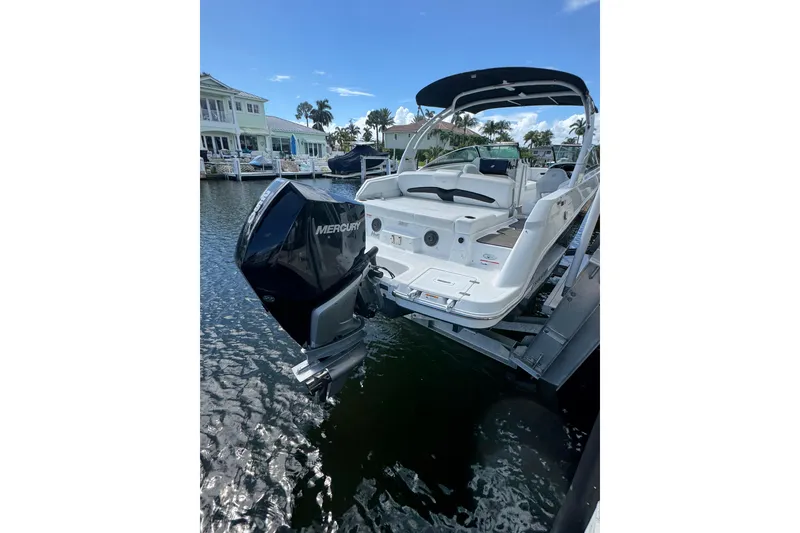 Slide: The Image of 2023 Four Winns HD5 OB boat with Mercury outboard motor on a lift. - 6