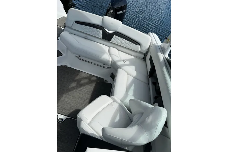 Slide: The Image of 2023 Four Winns HD5 OB boat interior with white seating and water view. - 8