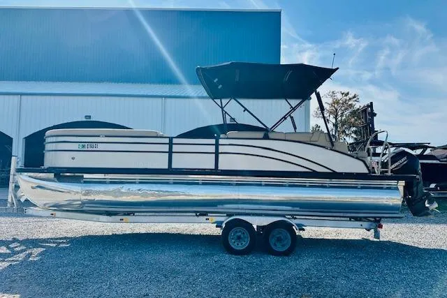 Slide: The Image of 2021 Harris 250 Cruiser pontoon boat on trailer, parked outdoors. - 4