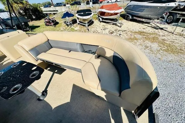 Slide: The Image of 2021 Harris 250 Cruiser boat interior with beige seating and cupholders. - 8