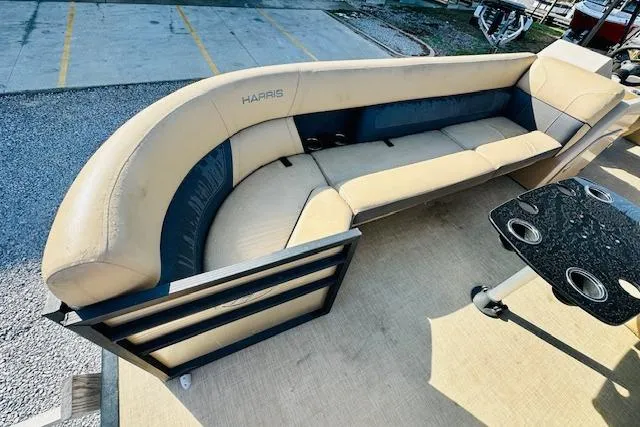 Slide: The Image of 2021 Harris 250 Cruiser boat interior with beige seating and black table. - 9