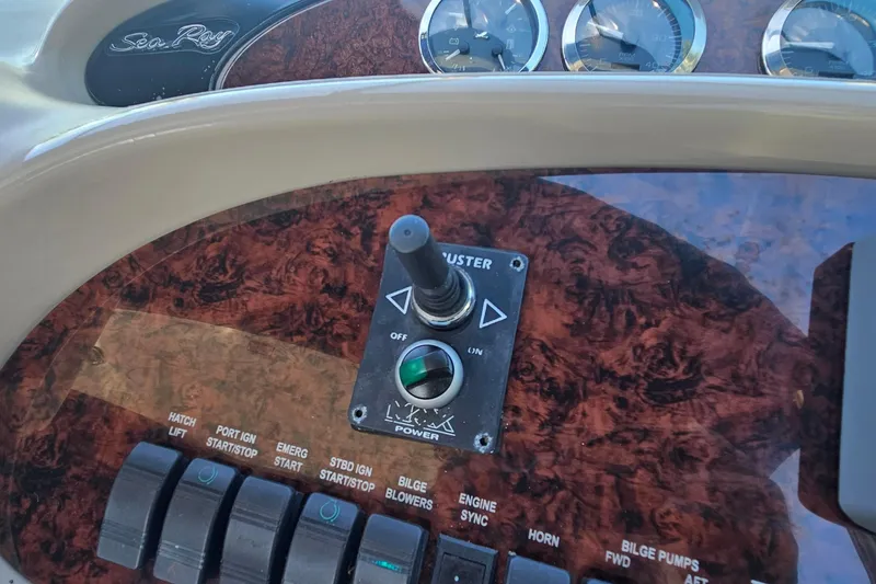 Slide: The Image of Control panel of a 2004 Sea Ray 380 Sundancer boat with switches and gauges. - 10