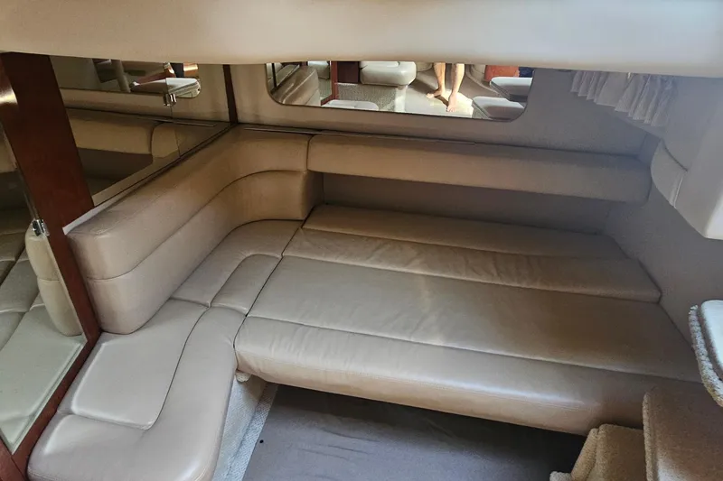 Slide: The Image of Interior of 2004 Sea Ray 380 Sundancer with beige leather seating and mirrored walls. - 19