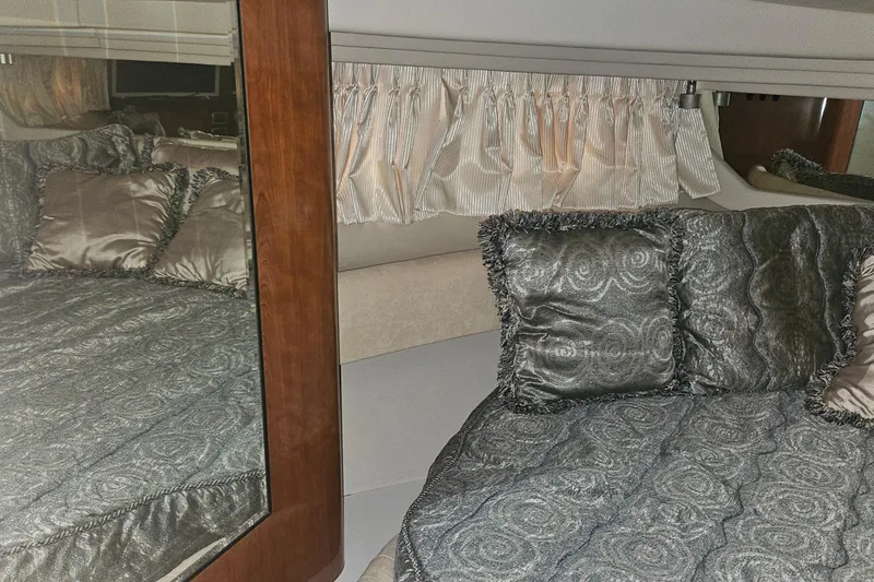 Slide: The Image of Luxurious cabin interior of 2004 Sea Ray 380 Sundancer with elegant bedding and pillows. - 21
