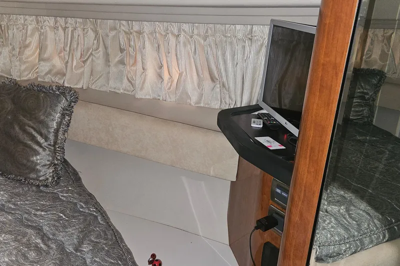 Slide: The Image of Interior cabin of 2004 Sea Ray 380 Sundancer with TV and elegant bedding. - 22