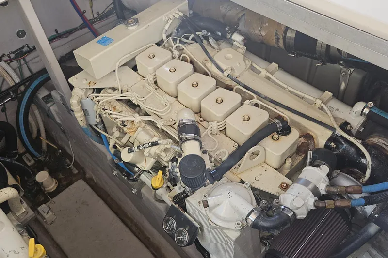 Slide: The Image of Engine compartment of a 2004 Sea Ray 380 Sundancer boat, showcasing detailed mechanical components. - 26