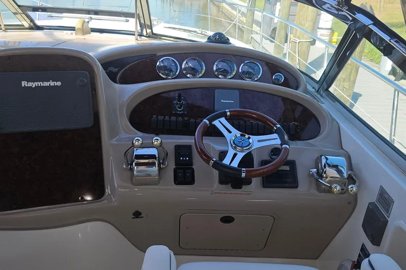 Slide: The Image of Helm of 2004 Sea Ray 380 Sundancer with Raymarine navigation system and wooden steering wheel. - 5