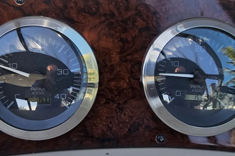 Slide: The Image of Close-up of 2004 Sea Ray 380 Sundancer RPM gauges on a wooden dashboard. - 9