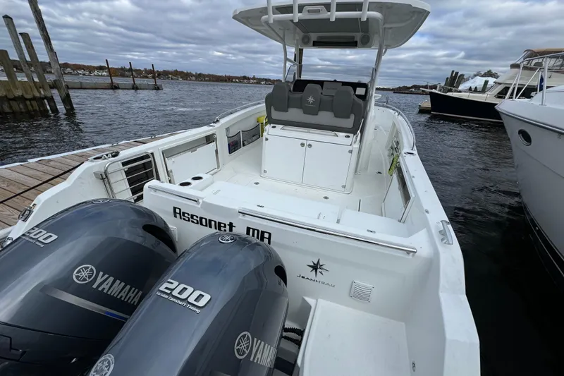 Slide: The Image of 2023 Jeanneau Leader 9.0 CC boat docked with Yamaha engines, cloudy sky background. - 2