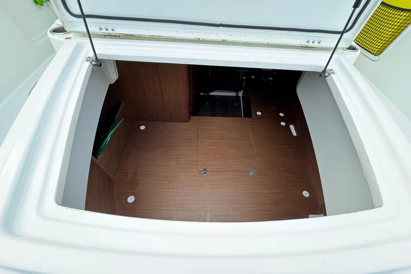 Slide: The Image of 2023 Jeanneau Leader 9.0 CC boat interior storage compartment with wooden flooring. - 8