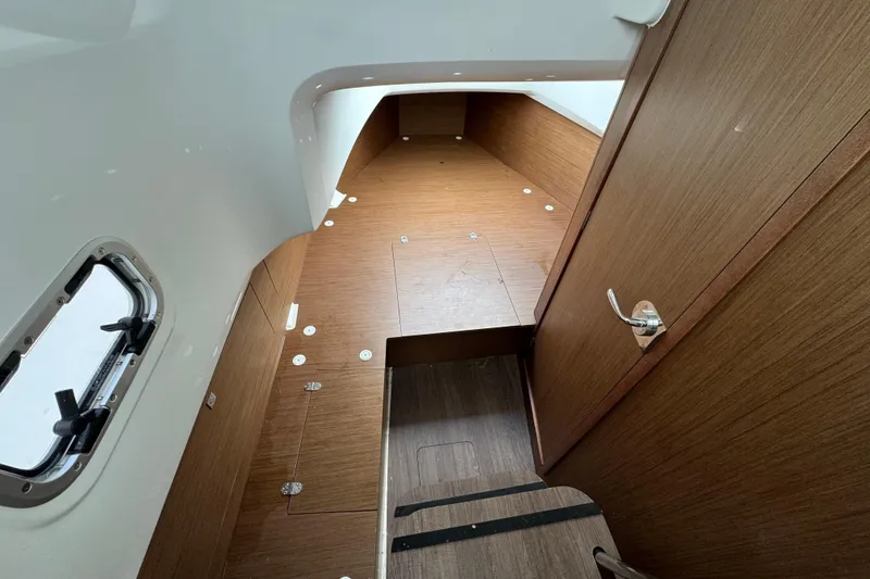 Slide: The Image of 2023 Jeanneau Leader 9.0 CC cabin interior with wood finish and window view. - 9