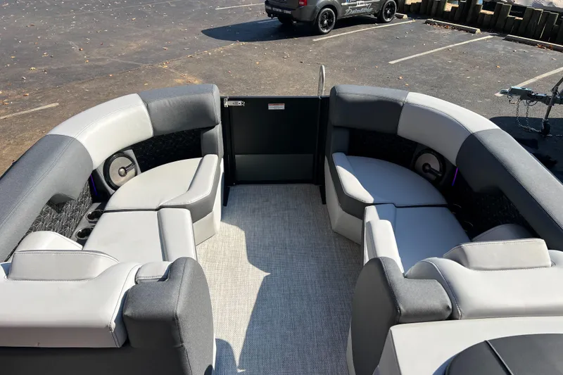 Slide: The Image of 2026 Alera M23Q boat interior with gray seating and carpeted floor. - 3