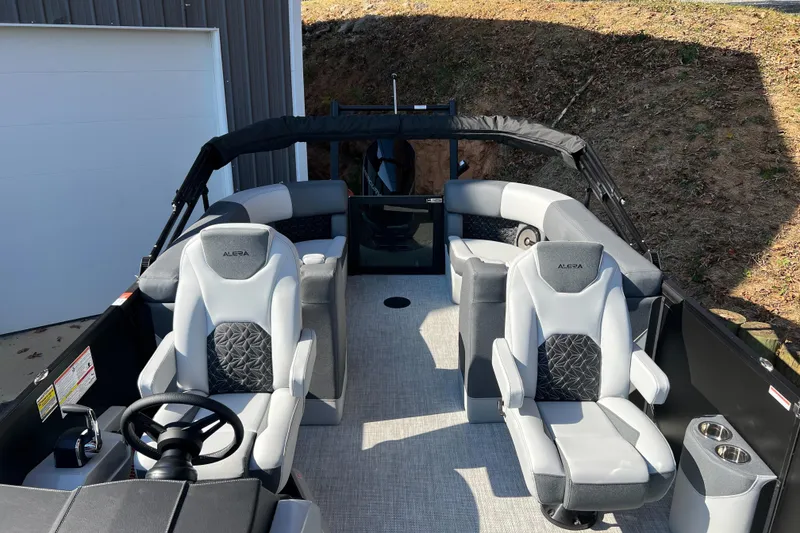 Slide: The Image of 2026 Alera M23Q boat interior with modern seating and steering wheel. - 4