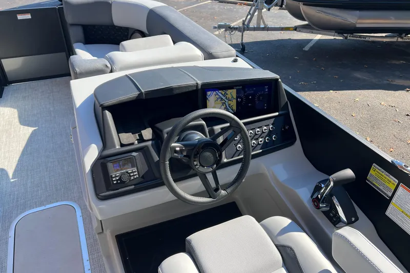 Slide: The Image of Interior of 2026 Alera M23Q boat with modern steering and navigation controls. - 6
