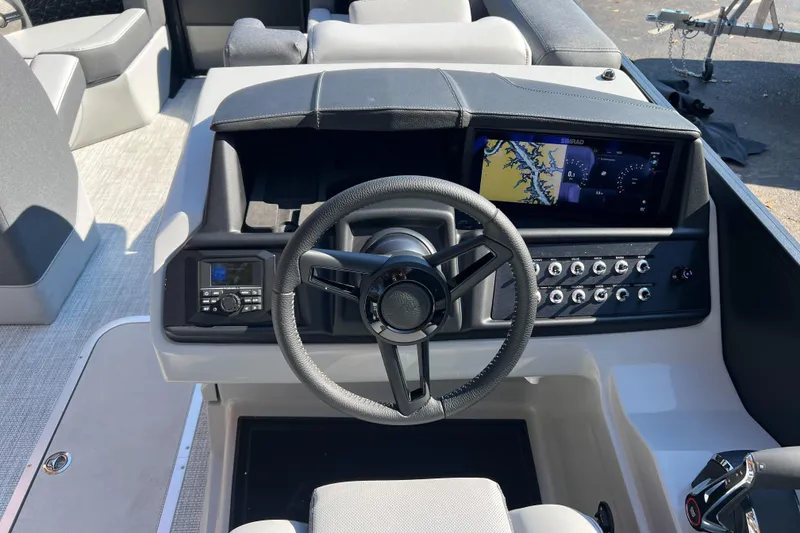 Slide: The Image of Cockpit of 2026 Alera M23Q boat with steering wheel and navigation display. - 7
